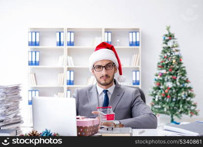 Young businessman celebrating christmas in the office