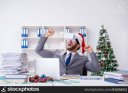 Young businessman celebrating christmas in the office