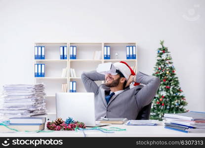 Young businessman celebrating christmas in the office