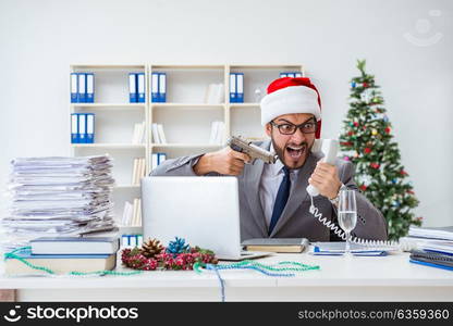 Young businessman celebrating christmas in the office