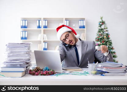 Young businessman celebrating christmas in the office. The young businessman celebrating christmas in the office