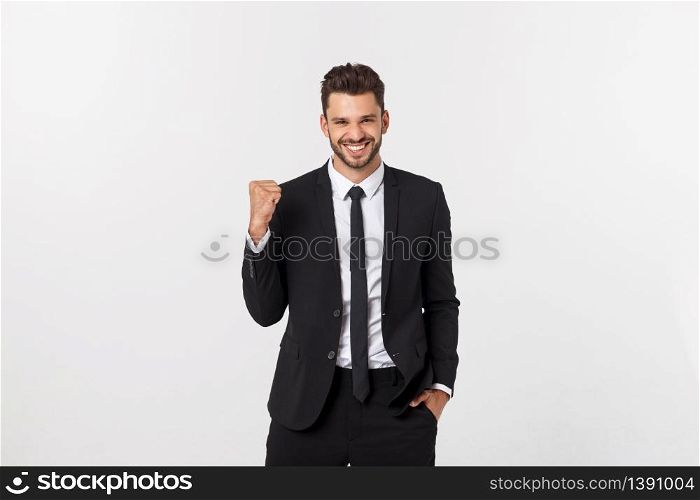 Young businessman celebrating his success over gray background. Young businessman celebrating his success over gray background.