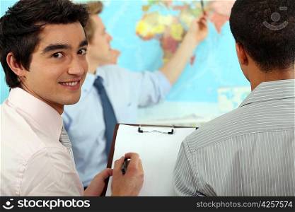 Young businessman discussing a map