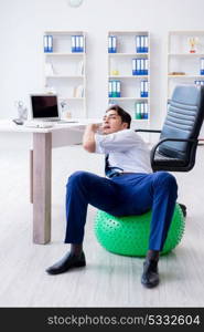 Young businessman doing sports stretching at workplace