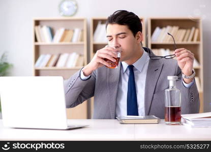 Young businessman drinking from stress