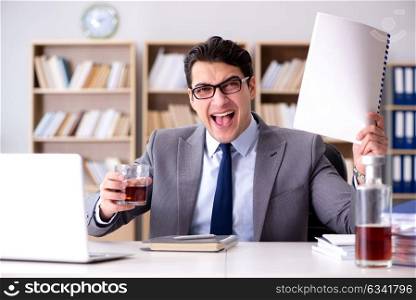 Young businessman drinking from stress
