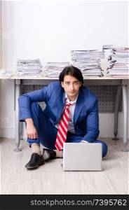 Young businessman employee unhappy with excessive work 