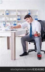 Young businessman exercising with elastic expander in office. The young businessman exercising with elastic expander in office