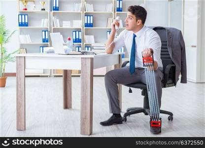 Young businessman exercising with elastic expander in office