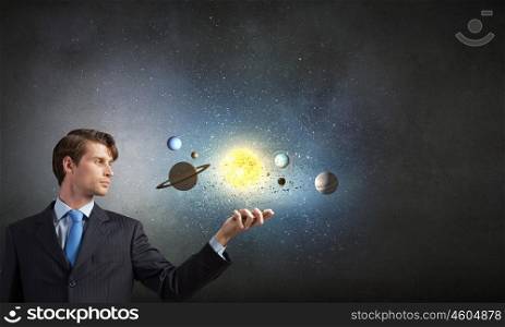 Young businessman exploring planets of sun system. Mysteries of space