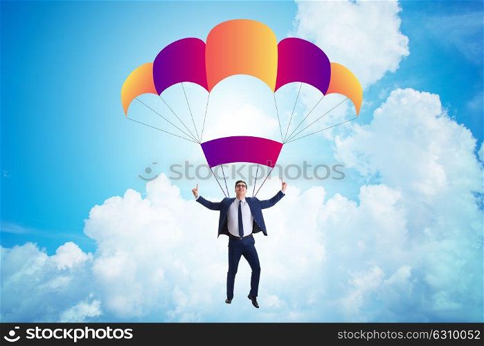 Young businessman falling on parachute in business concept