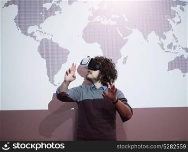 young businessman getting experience using VR-headset glasses of virtual reality at late night startup office building