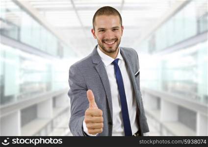 young businessman going thumb up, at the office
