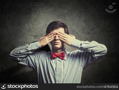 Young businessman. Handsome businessman closing his eyes with palms