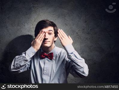 Young businessman. Handsome businessman closing his eyes with palms