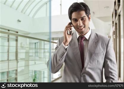 Young businessman having conversation on phone