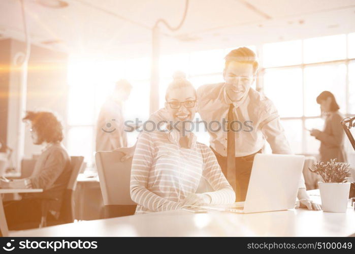 Young businessman helping his colleague to fix the problem at the work