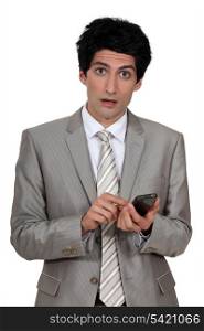young businessman holding a cell phone