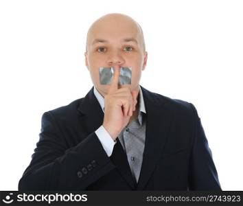 young businessman holding a finger to his mouth. Isolated on white background
