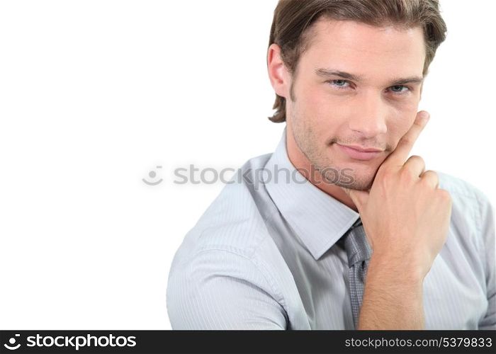 Young businessman holding chin
