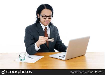 Young Businessman Holding Credit Card And Using Laptop