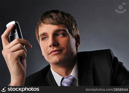 Young businessman holding mobile phone