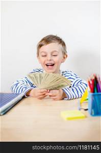 Young businessman holds money in his hands, american hundred dollars cash. American one hundred dollars in cash. Portrait boy with banknotes.. Young businessman holds money in his hands, american hundred dollars cash. American one hundred dollars in cash.