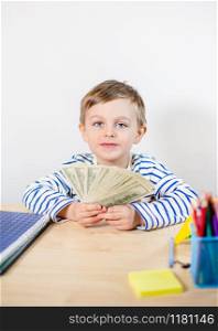 Young businessman holds money in his hands, american hundred dollars cash. American one hundred dollars in cash. Portrait boy with banknotes.. Young businessman holds money in his hands, american hundred dollars cash. American one hundred dollars in cash.