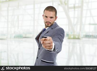 young businessman in a suit pointing with his finger at the office