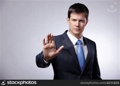 Young businessman in a suit shows his hand