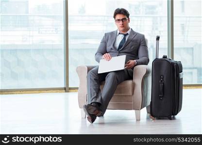 Young businessman in airport business lounge waiting for flight