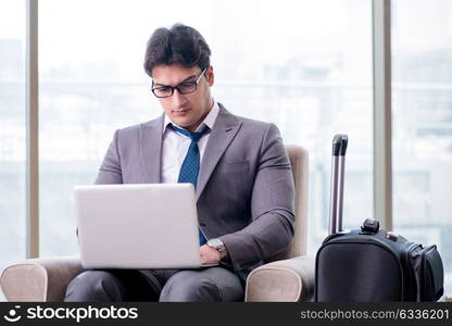 Young businessman in airport business lounge waiting for flight