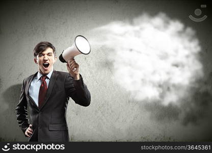 young businessman in black suit screaming into megaphone