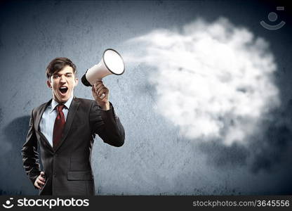 young businessman in black suit screaming into megaphone