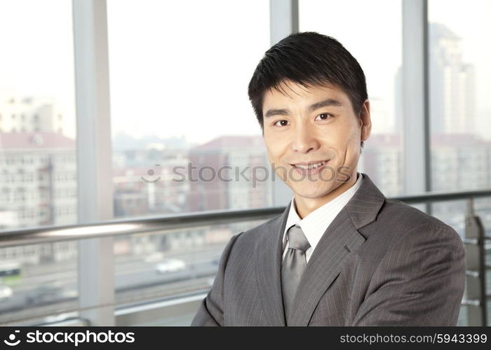 Young Businessman in front of window