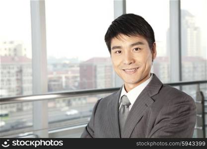Young Businessman in front of window