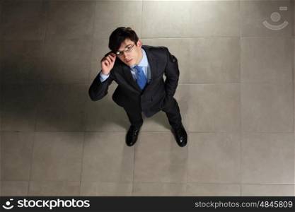 Young businessman in glasses. Image of young businessman in glasses. Top view