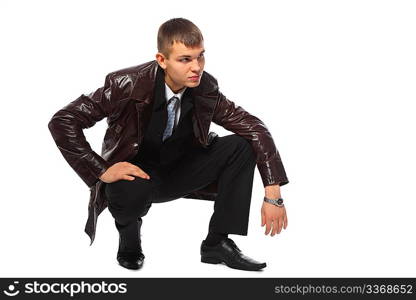 Young businessman in leather jacket squats