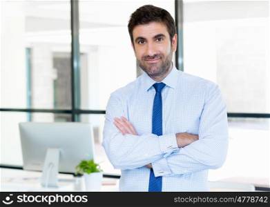 Young businessman in office thinking about something