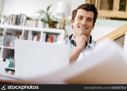 Young businessman in office. Young businessman working in office