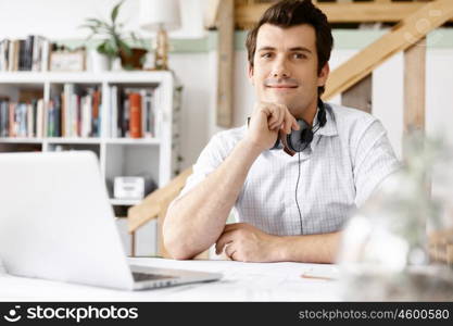 Young businessman in office. Young businessman working in office