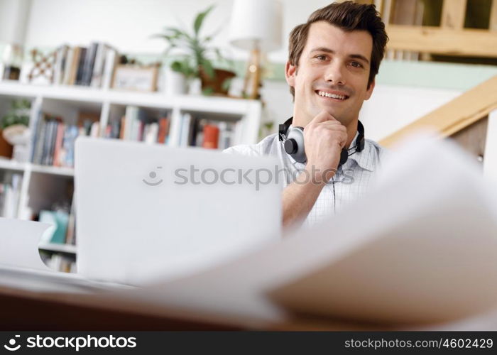 Young businessman in office. Young businessman working in office