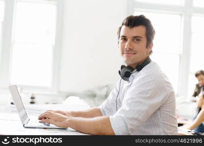 Young businessman in office. Young businessman working in office