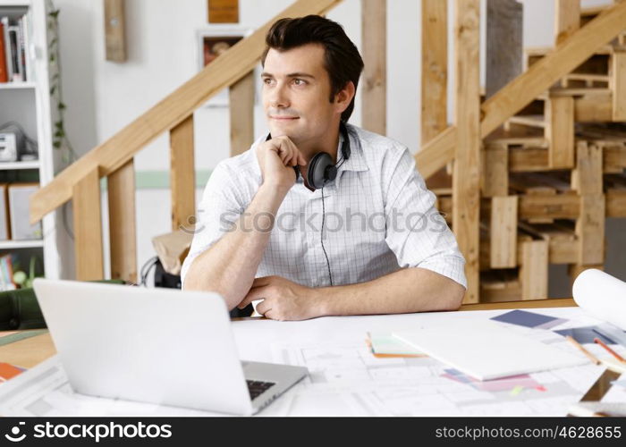 Young businessman in office. Young businessman working in office