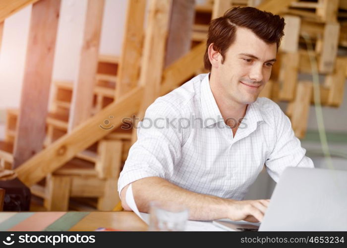 Young businessman in office. Young businessman working in office