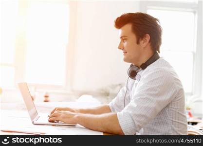 Young businessman in office. Young businessman working in office
