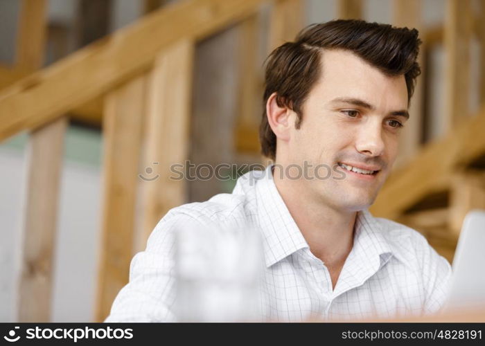 Young businessman in office. Young businessman working in office