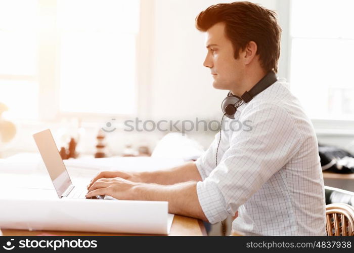 Young businessman in office. Young businessman working in office