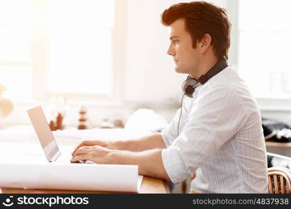 Young businessman in office. Young businessman working in office