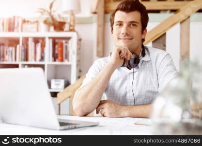 Young businessman in office. Young businessman working in office